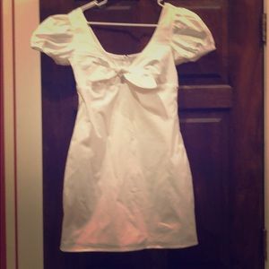 White cotton dress with tie at chest.